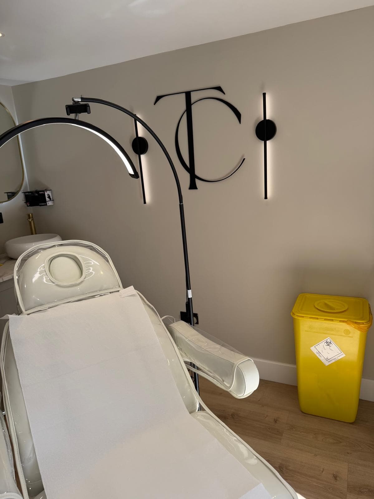 The treatment room at The Clinic, with the TC monogram on the wall